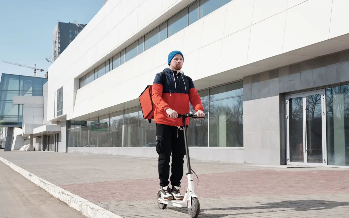 A courier heading out with an insulated bag, the delivery radius a site has to state honestly