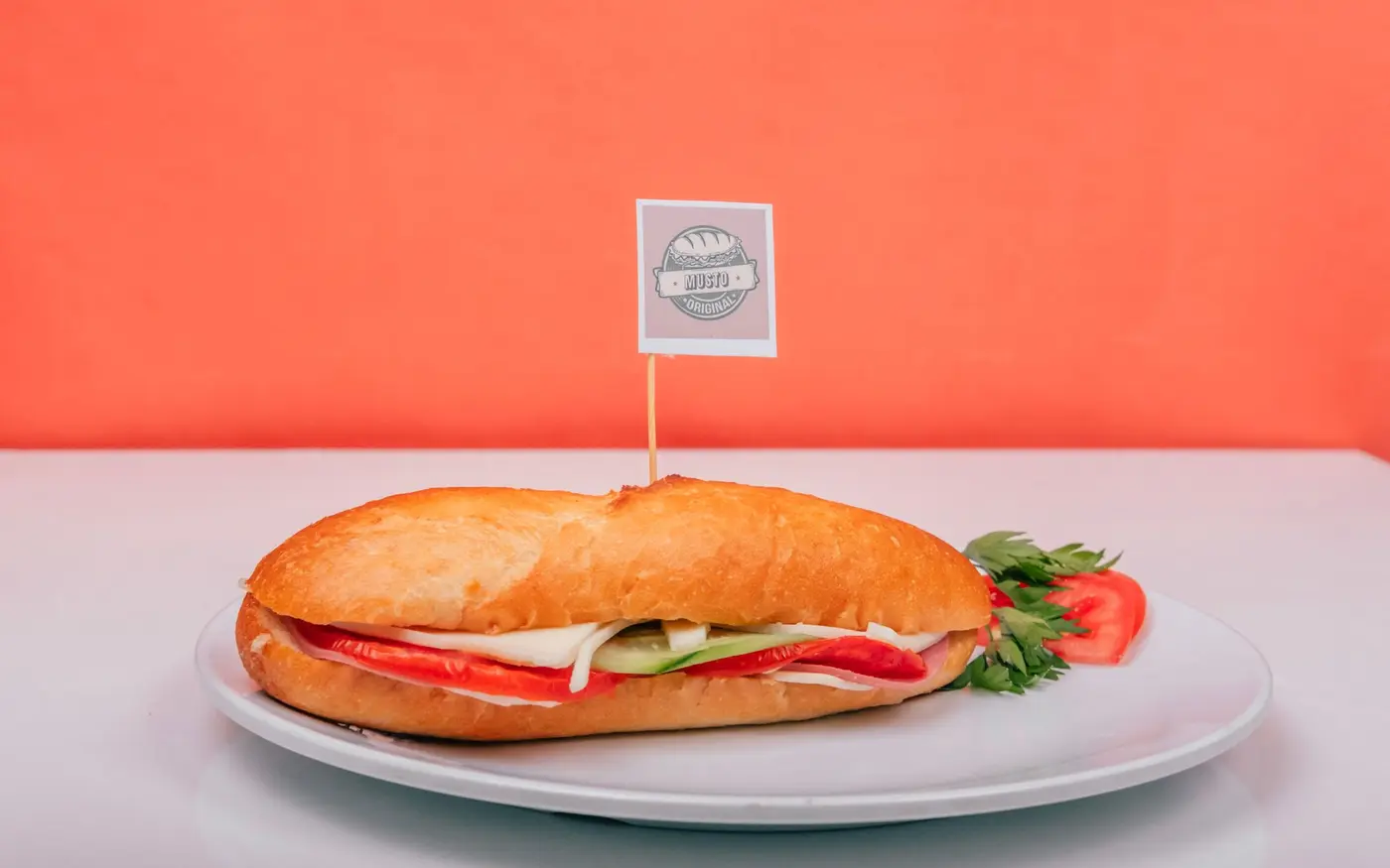 A freshly made sub sandwich filled with vegetables on a plate